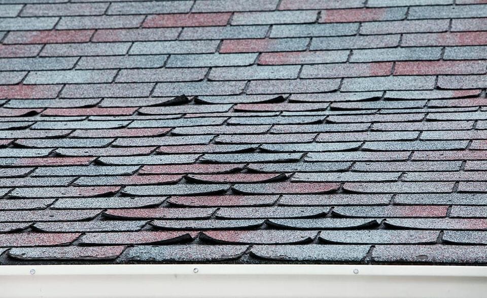 A broken asphalt shingle roof in Houston that may cause roof leak in the future