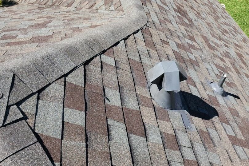 Ridge cap and roof vent detail on an asphalt shingle roof